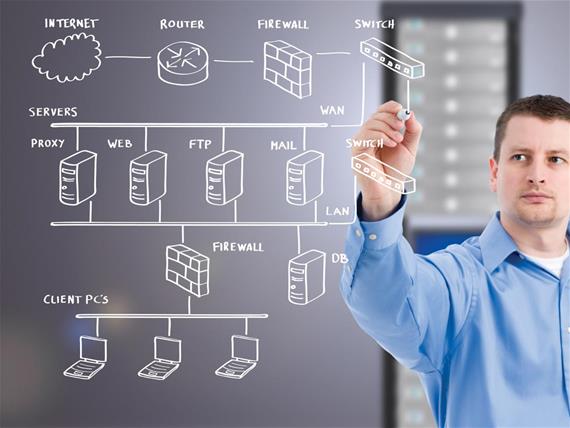 IT worker drawing computer network on digital screen.